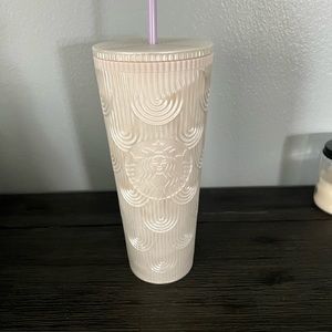 Venti pearl white cup with light purple straw.